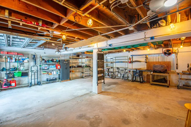 a view of a garage with storage and a car