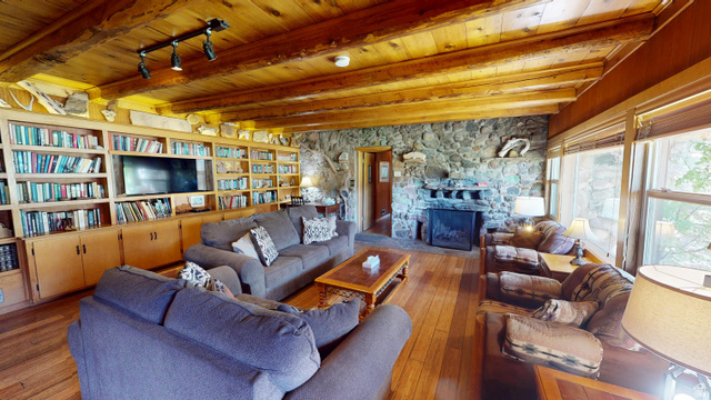 315 Abbey Road Moab, UT 84532 - Photo 39 of 46 Living area featuring a stone fireplace, hardwood / wood-style floors, and a wooden ceiling with exposed beams
