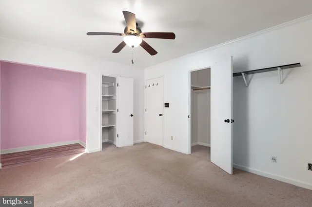 a view of a livingroom with a ceiling fan and window