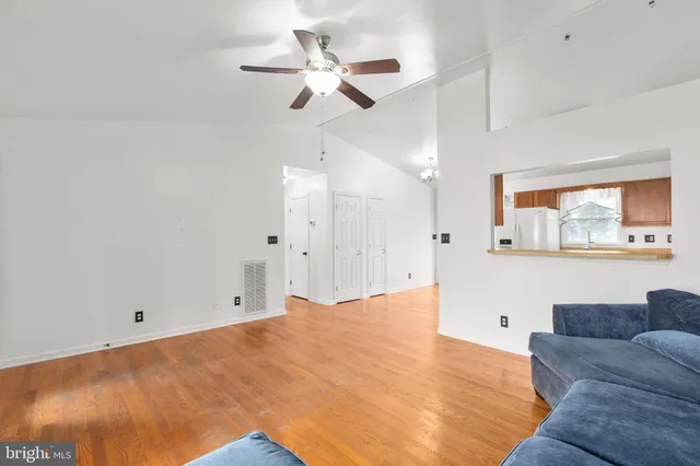 a living room with furniture and a ceiling fan