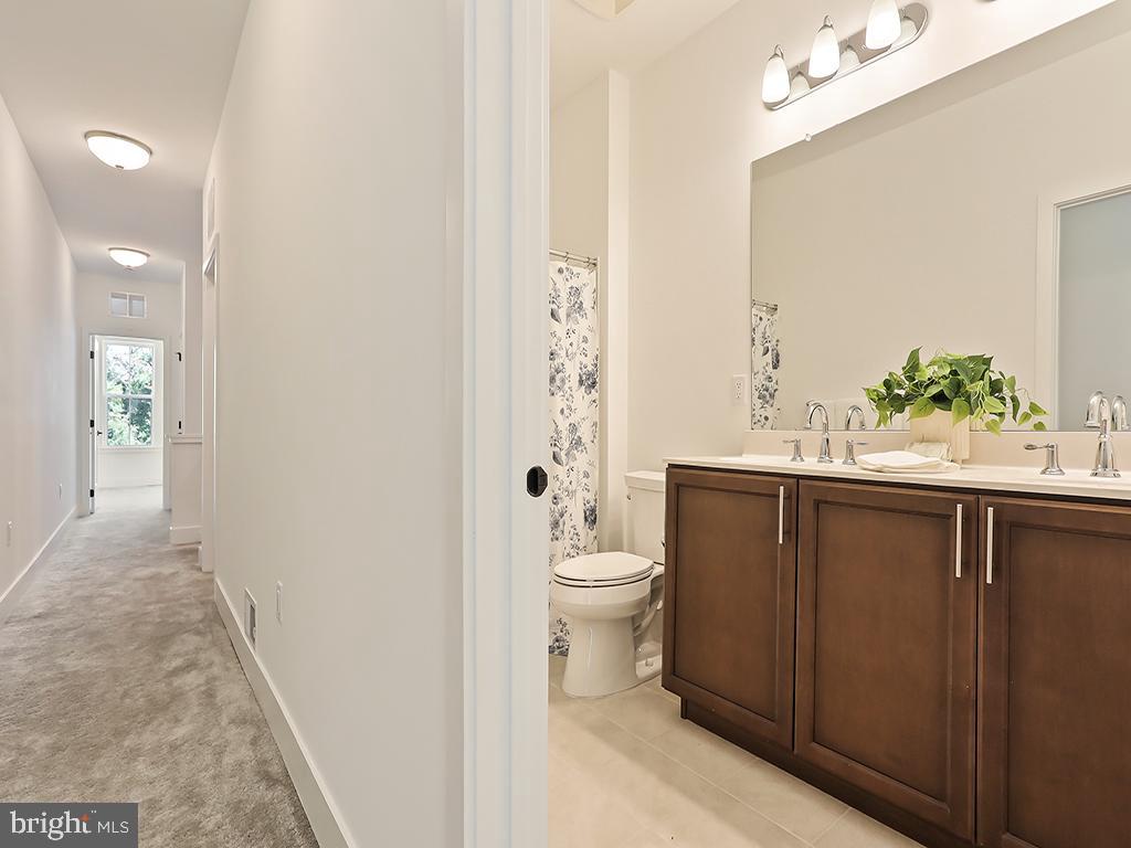6105 Vivaldi Road Princeton, NJ 08540 - Photo 17 of 28 a bathroom with a sink a toilet and shower curtain