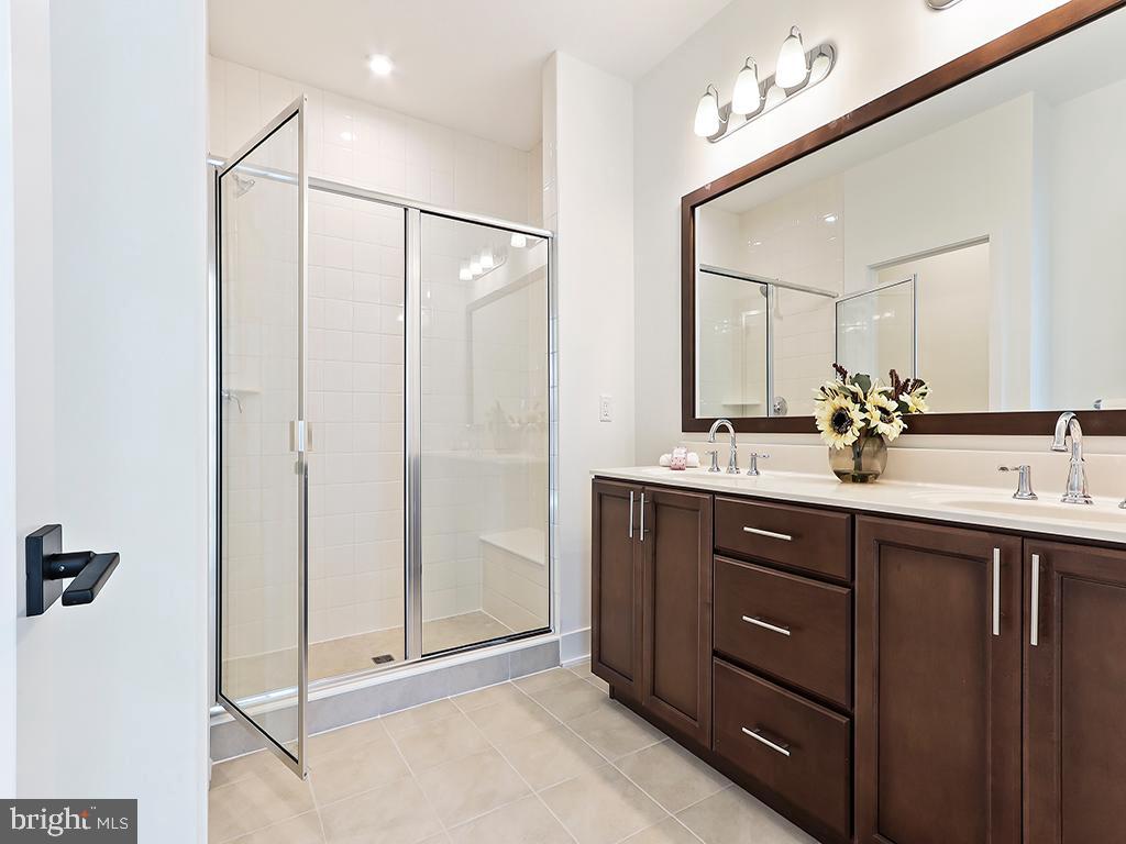 6105 Vivaldi Road Princeton, NJ 08540 - Photo 22 of 28 a bathroom with a shower sink and mirror