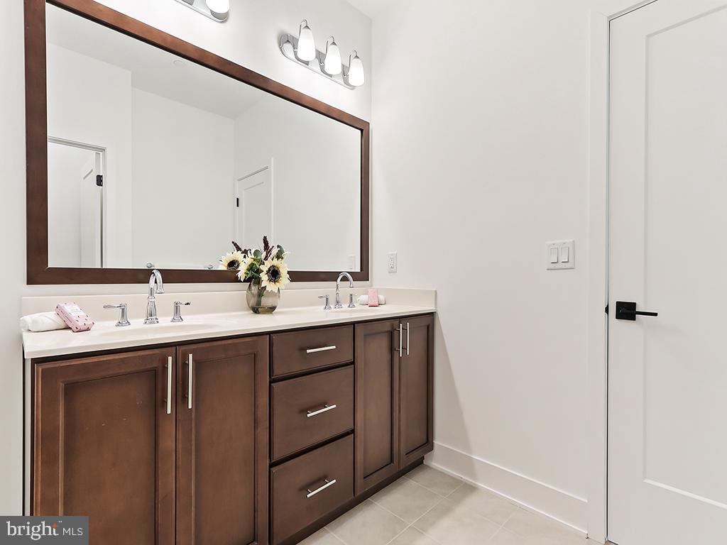 6105 Vivaldi Road Princeton, NJ 08540 - Photo 24 of 28 a bathroom with a double vanity sink and a mirror