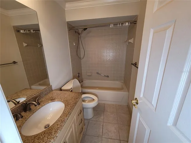 a view of a room with wooden floor and flat screen tv