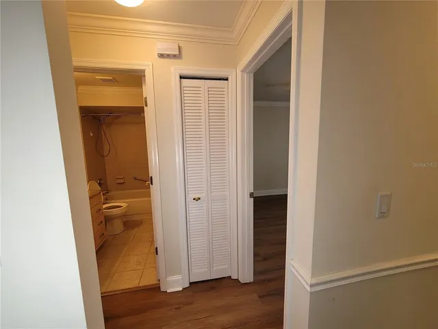 a view of empty room with wooden floor