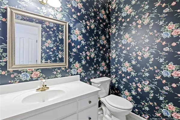 a bathroom with a toilet sink and mirror
