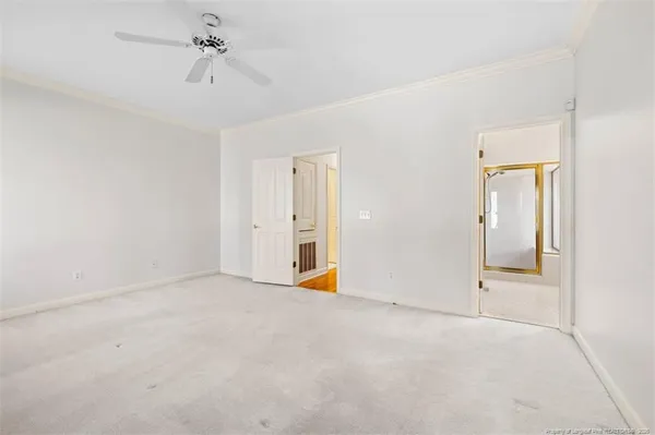 an empty room with fan and windows