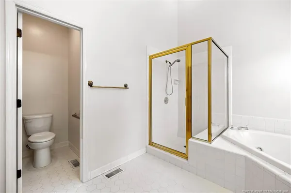 a bathroom with a granite countertop sink mirror vanity and toilet