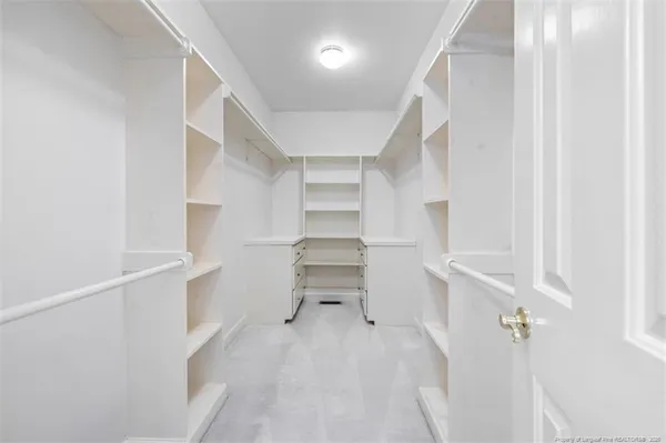 a view of walk in closet with empty racks