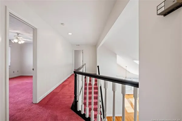 a view of a hallway with windows and stairs