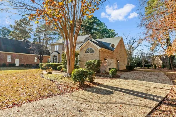 a front view of a house with a yard covered in snow