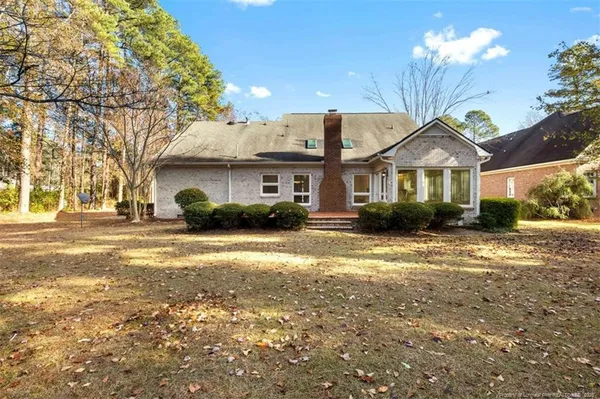 a front view of a house with a yard and outdoor seating