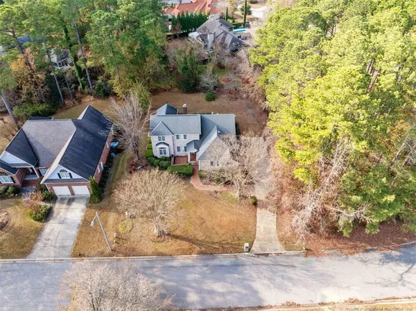 an aerial view of a house with yard and seating space