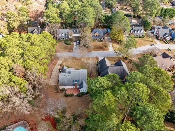 an aerial view of a house with yard and parking