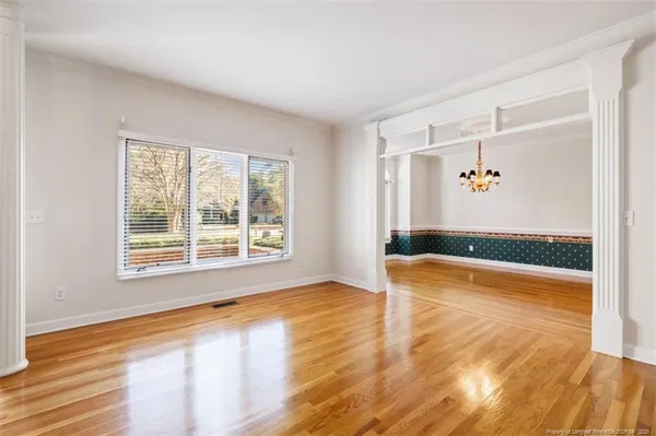 a view of a room with wooden floor and window