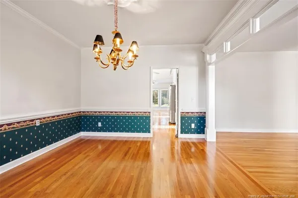 a view of wooden floor and windows in a room