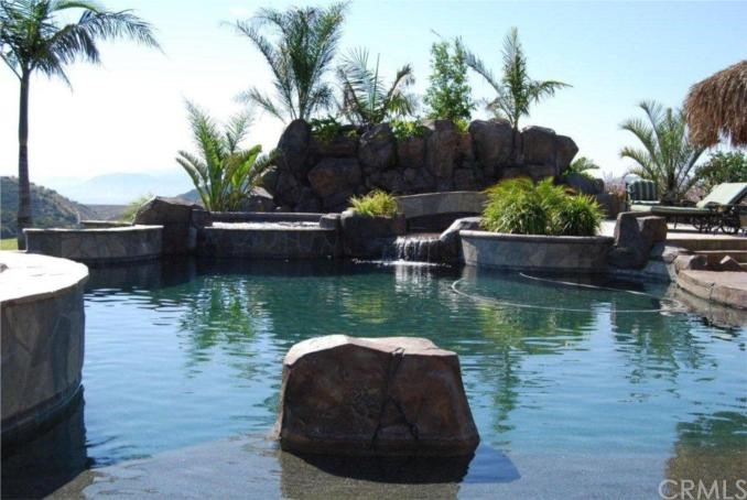 Incredible pebble sheen pool with swim up bar and 30 ft waterfall