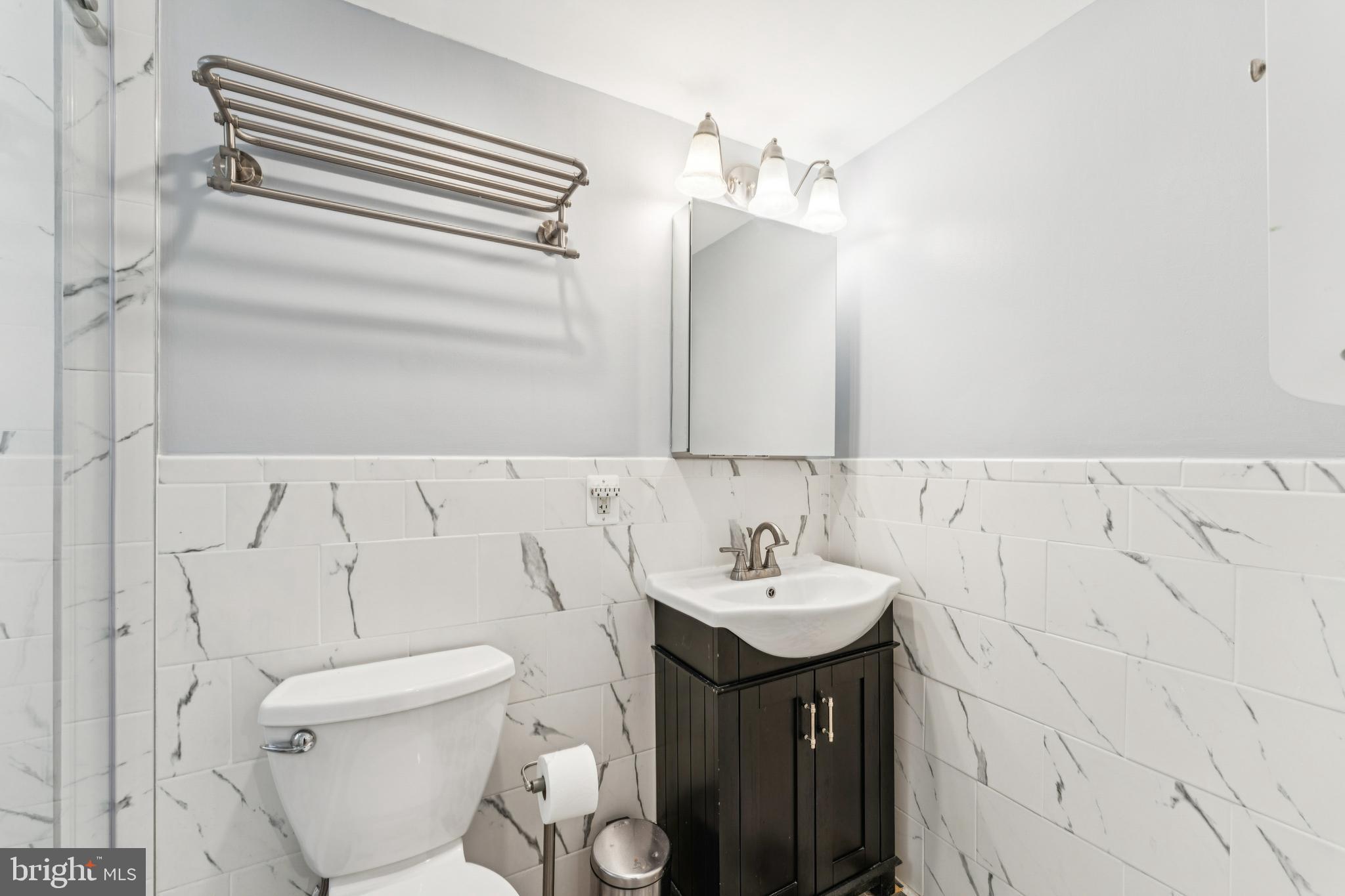 1701 16th Street Northwest, Unit 304 Washington, DC 20009 - Photo 11 of 18 a bathroom with a sink and mirror