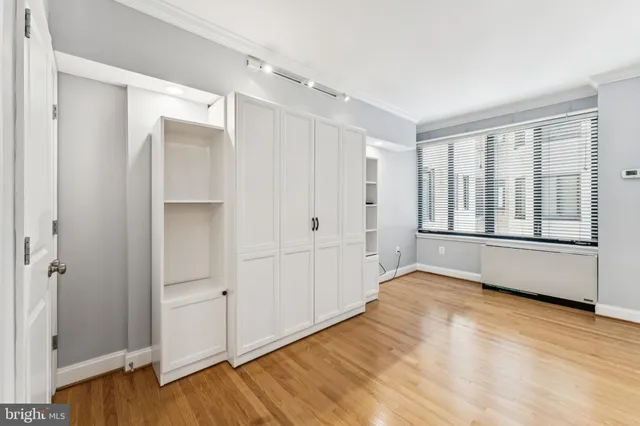 a view of an empty room with wooden floor