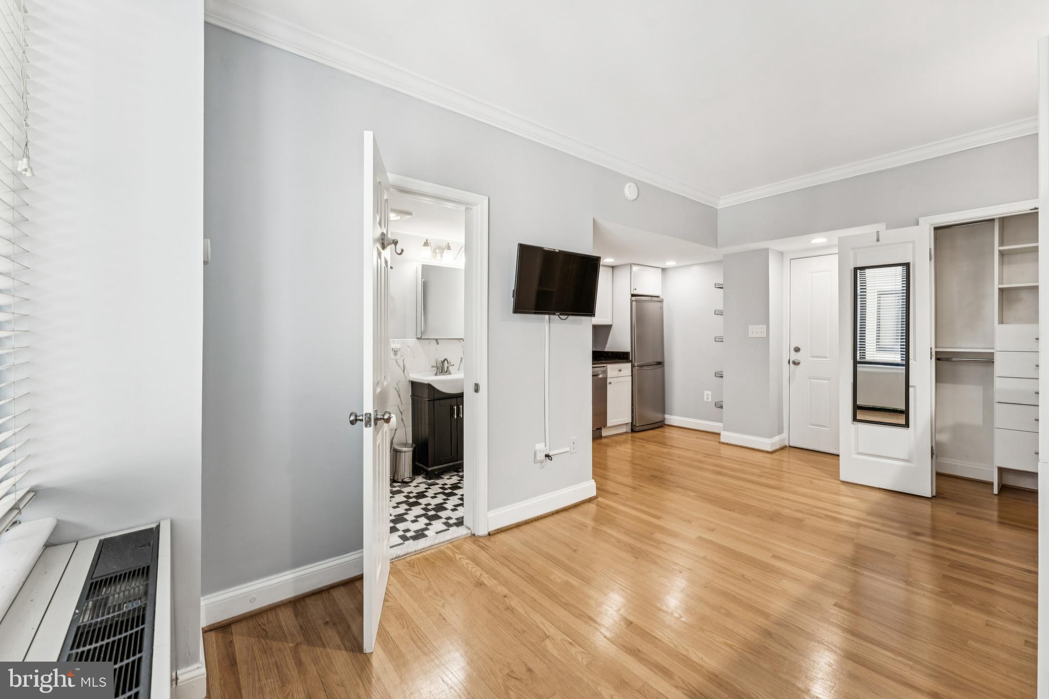 1701 16th Street Northwest, Unit 304 Washington, DC 20009 - Photo 5 of 15 a view of empty room with wooden floor