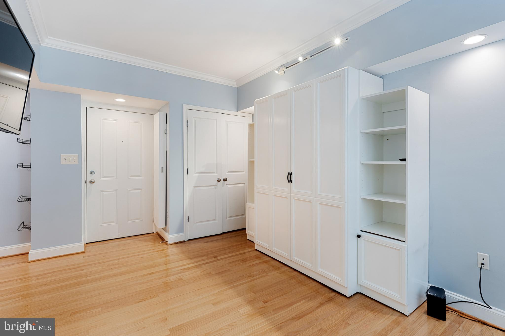 1701 16th Street Northwest, Unit 304 Washington, DC 20009 - Photo 6 of 18 a view of an empty room with wooden floor and closet