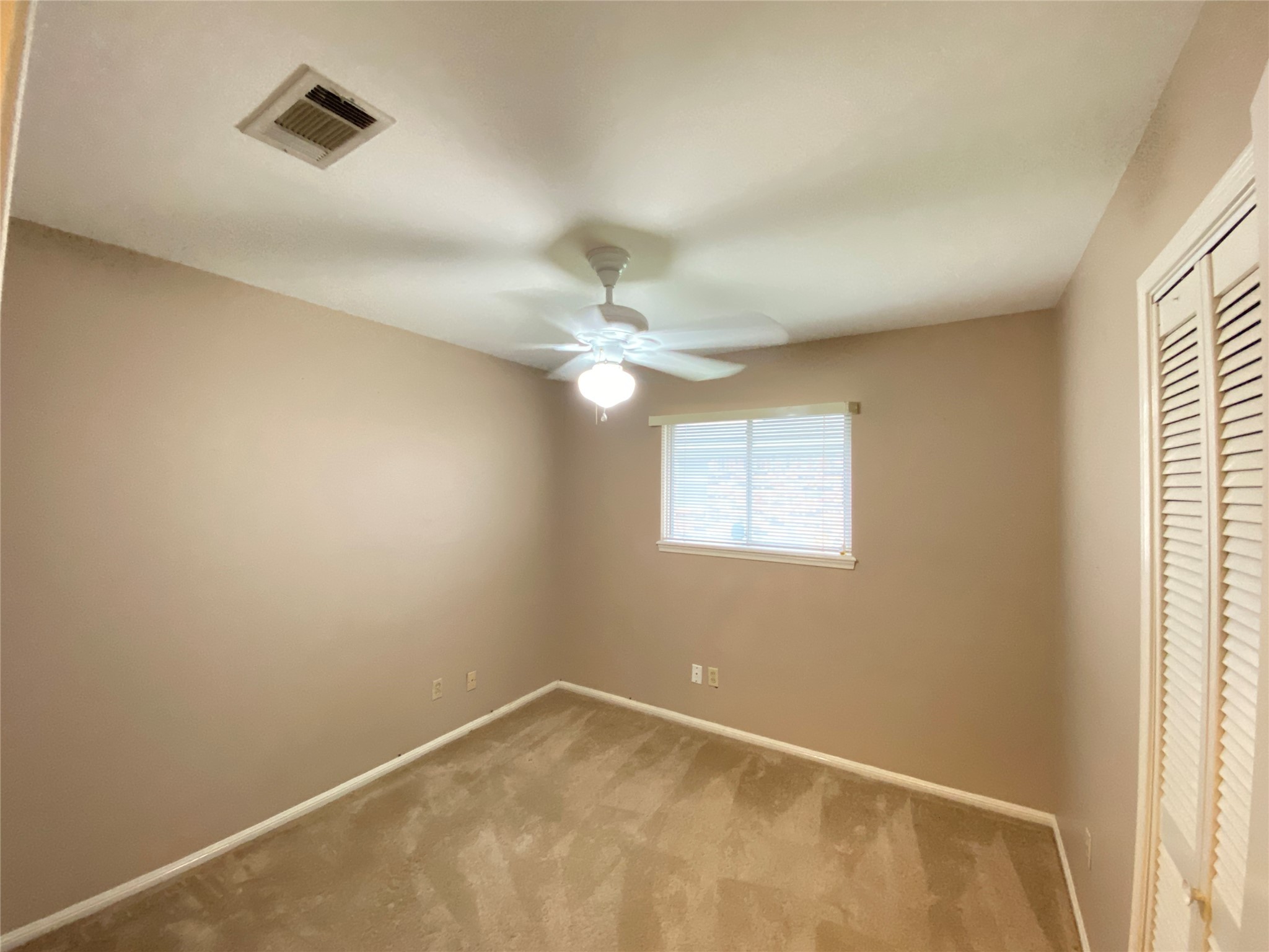 2233 Ripple Creek Drive Rosenberg, TX 77471 - Photo 18 of 39 an empty room with a window and a fan