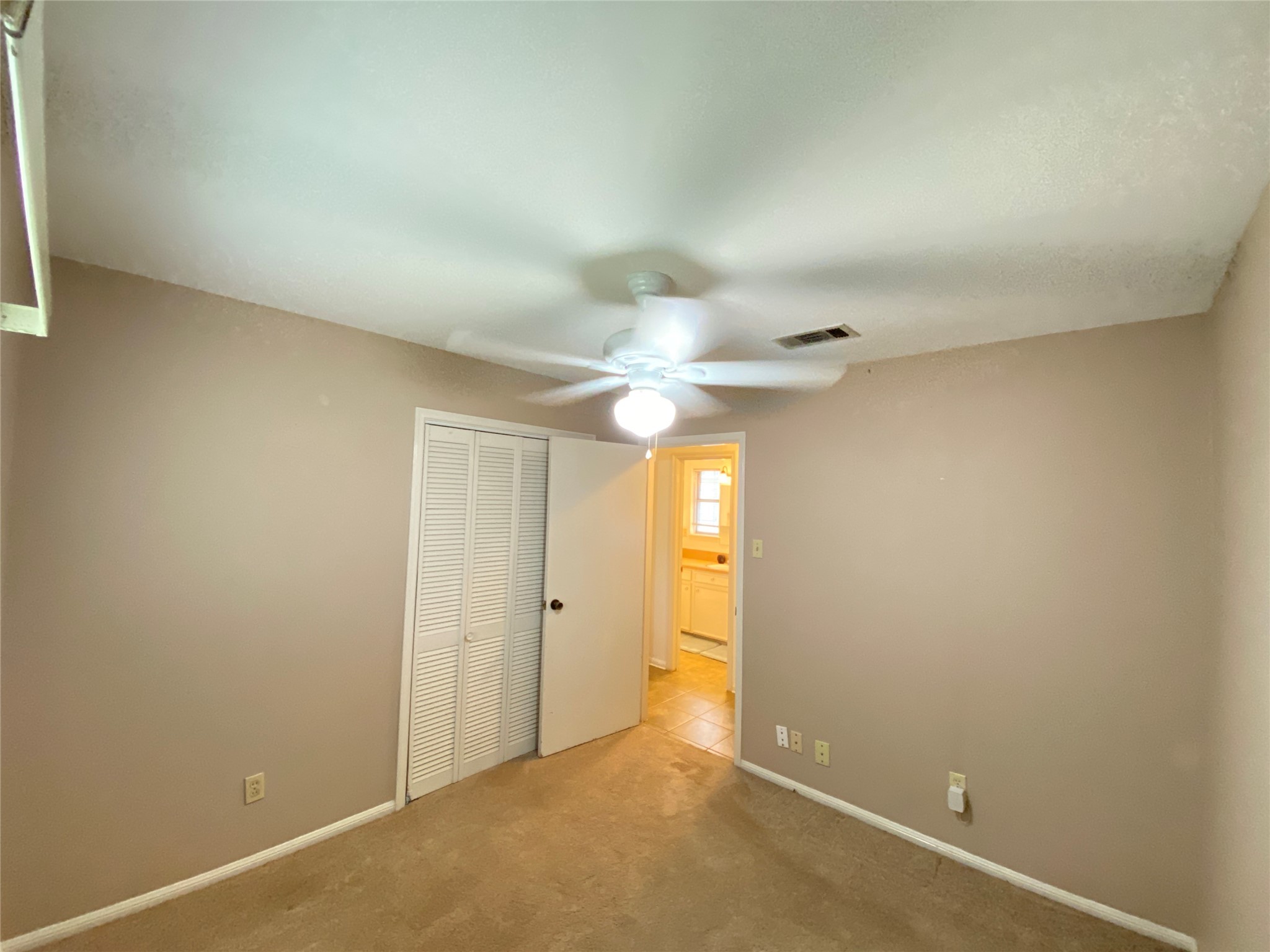 2233 Ripple Creek Drive Rosenberg, TX 77471 - Photo 22 of 39 an empty room with a ceiling fan and a window