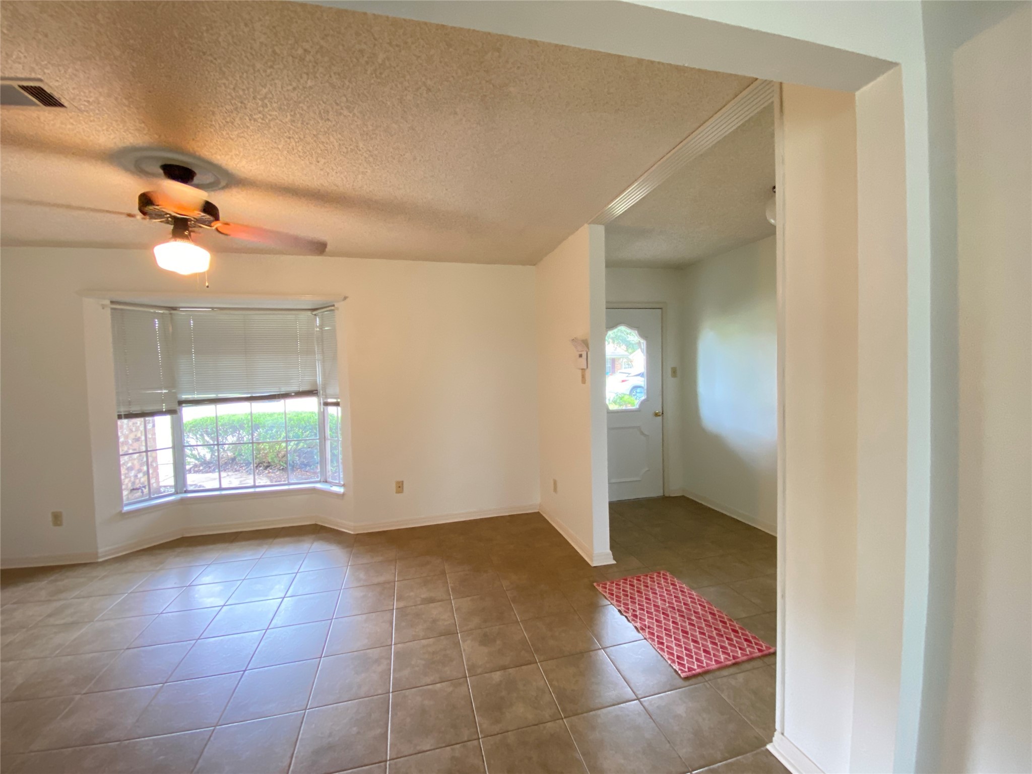 2233 Ripple Creek Drive Rosenberg, TX 77471 - Photo 5 of 39 an empty room with windows and fan