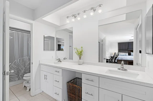 a bathroom with a sink vanity and mirror