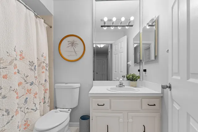 a bathroom with a toilet a sink and a mirror