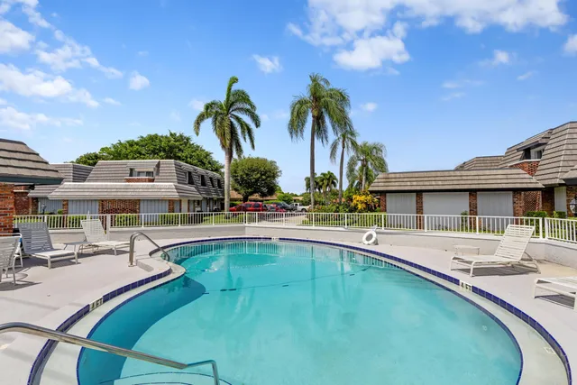 a swimming pool with outdoor seating and yard