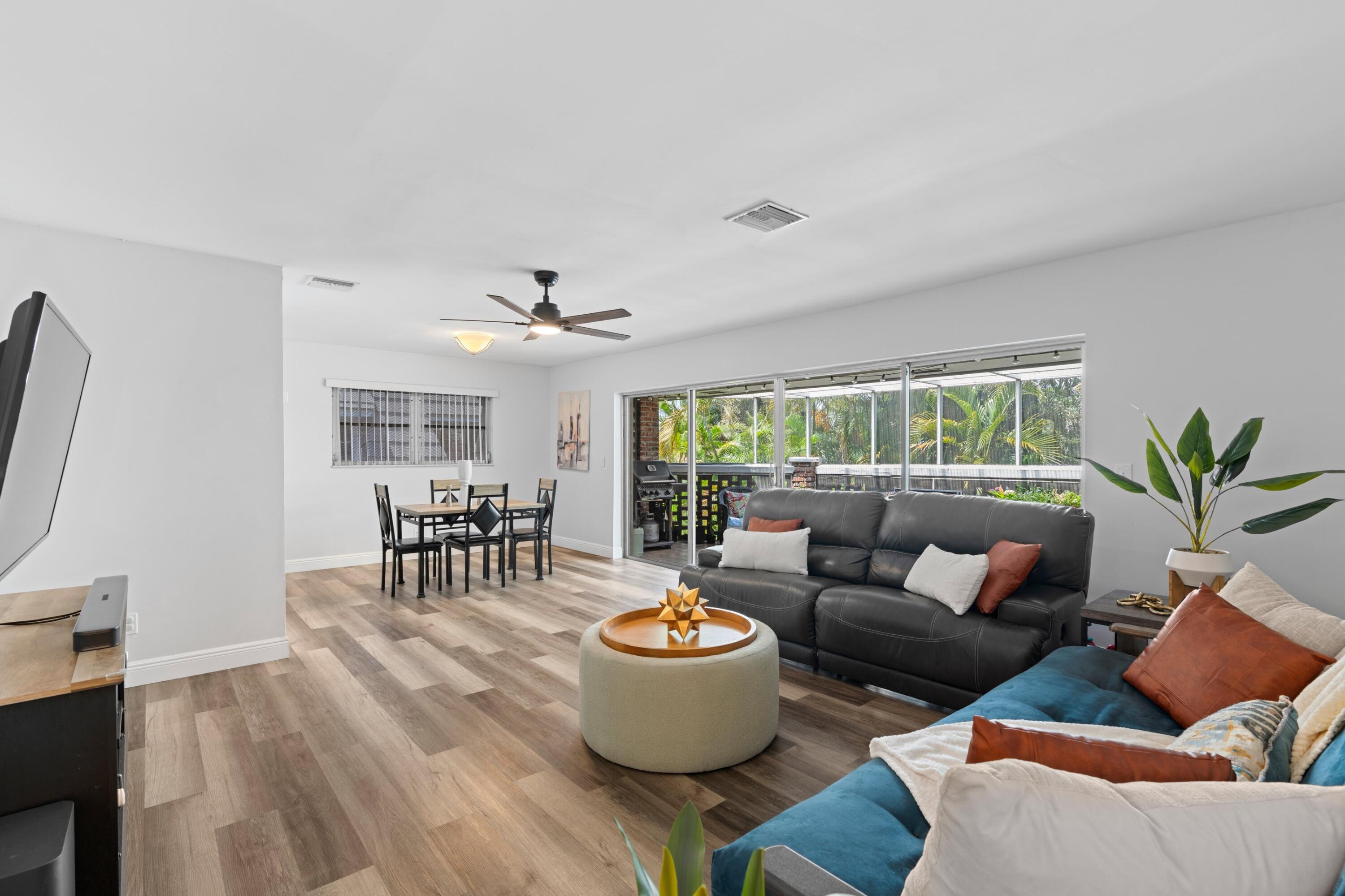 419 Pine Tree Court, Unit 21 Atlantis, FL 33462 - Photo 3 of 22 a living room with furniture and a large window