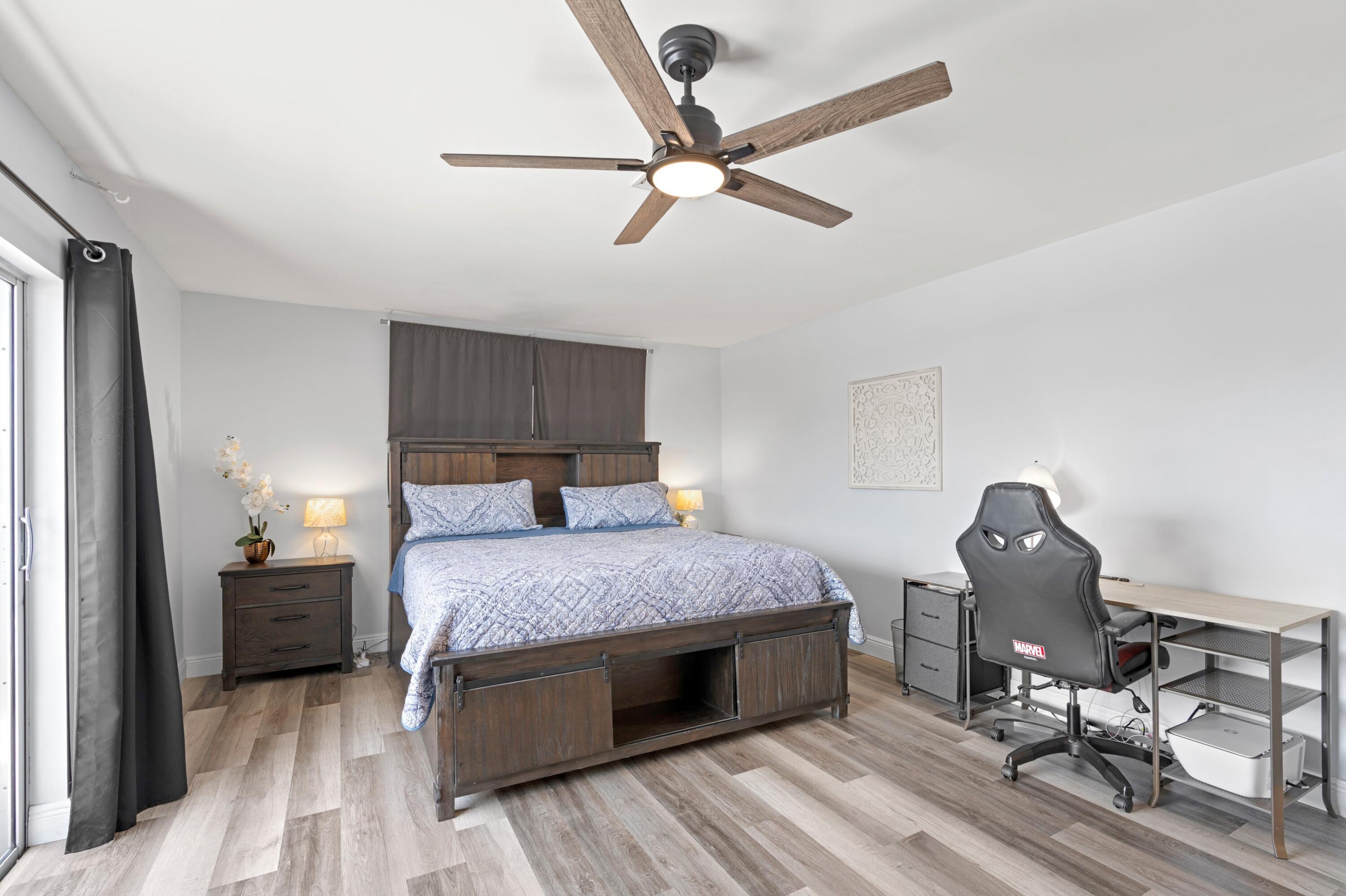 419 Pine Tree Court, Unit 21 Atlantis, FL 33462 - Photo 10 of 22 a bedroom with a bed and cabinets