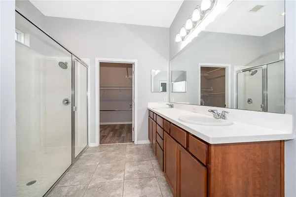 a bathroom with a sink a mirror and a shower
