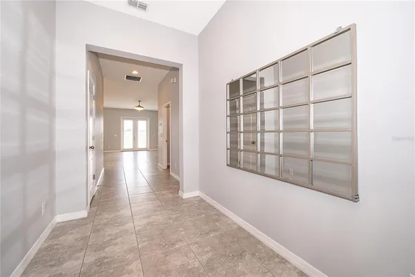an empty room with a window and a fan