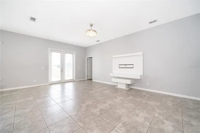 an aerial view of a house with a yard and lake view