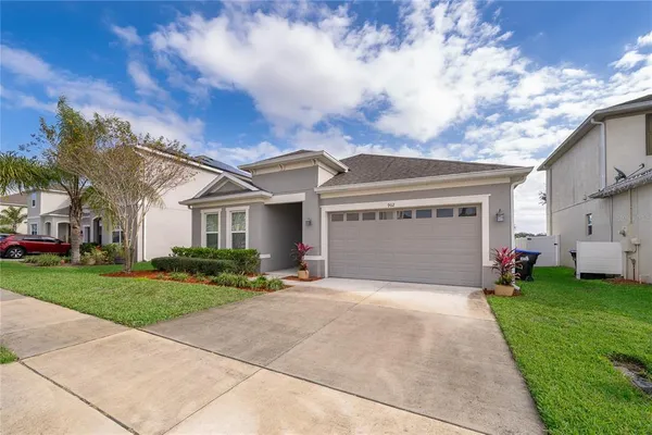 an aerial view of a house with a yard sitting space and swimming pool