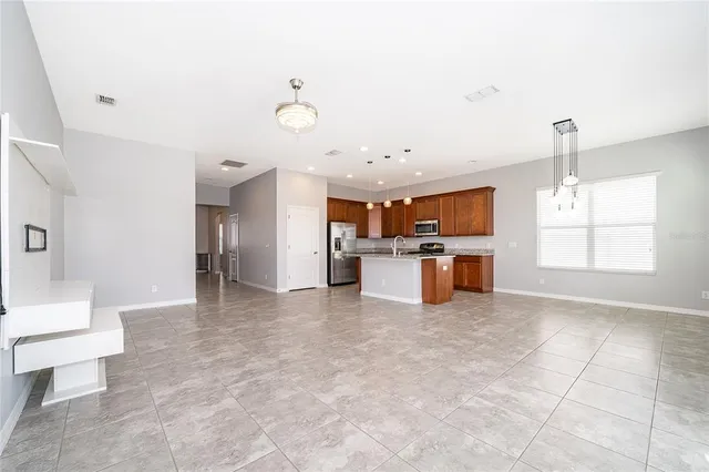 a view of kitchen with furniture and refrigerator
