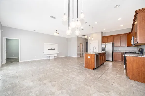 a view of kitchen and kitchen with stainless steel appliances