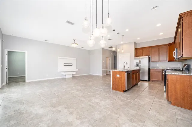 a view of kitchen and kitchen with stainless steel appliances