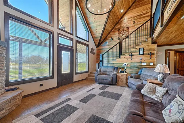 a living room with furniture a fireplace and a large window