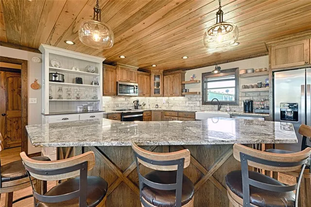 a kitchen with stainless steel appliances granite countertop a sink and a stove