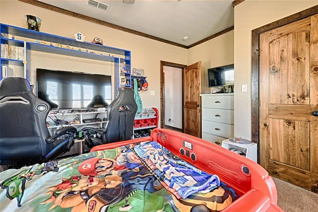 a bedroom with a bed and flat screen tv