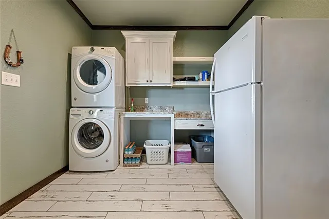 a utility room with sink dryer and washer