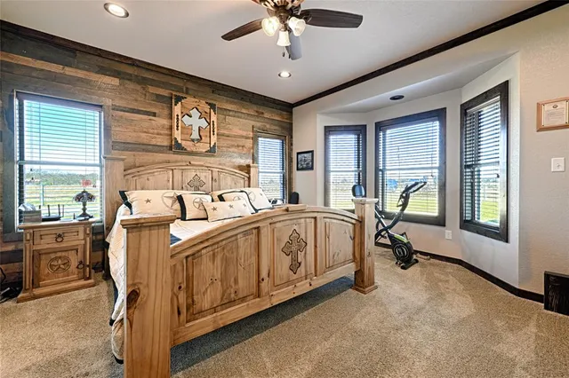 a spacious bedroom with a bed and a large window with the outer view