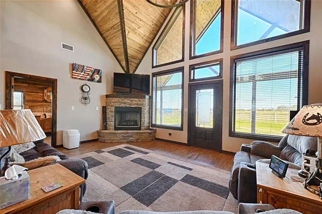 a living room with furniture a fireplace and a large window
