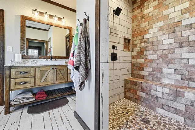 a view of bathroom with a sink and a mirror