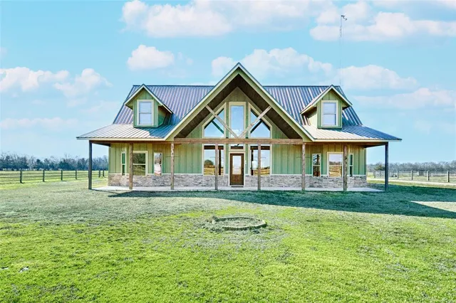 a front view of a house with a garden and porch