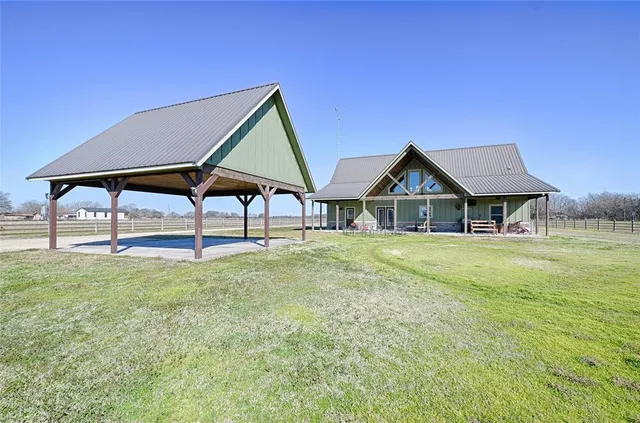 a view of an house with backyard space and balcony