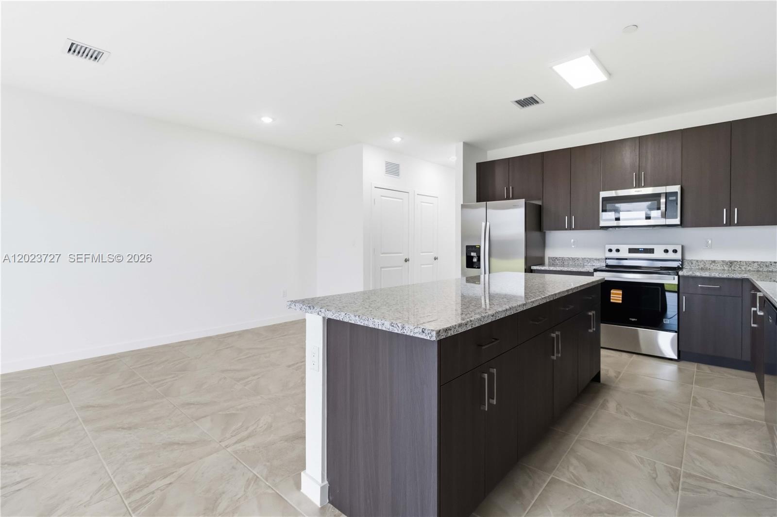 22348 Southwest 115th Court, Unit 22348 Miami, FL 33170 - Photo 10 of 37 a large kitchen with stainless steel appliances a sink and cabinets